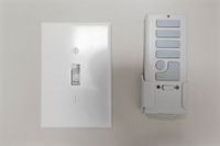 Modern light switch and remote panel offering convenient control and sleek design for contemporary living spaces.