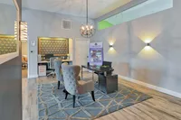 Elegant office space with plush seating, geometric-patterned walls, and stylish lighting fixtures, ideal for a professional setting.