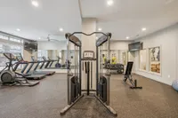 Modern fitness center with state-of-the-art cardio machines, weight stations, and a sleek design for an energizing workout experience.
