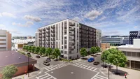 Modern apartment complex with spacious balconies nestled in a vibrant urban setting, featuring lush green trees along a bustling street corner.