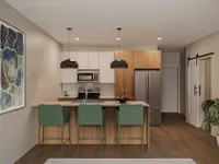 Modern kitchen with sleek appliances, stylish pendant lights, and cozy bar seating for a contemporary living experience.