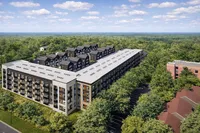 Modern apartment complex surrounded by lush green landscape, offering a tranquil living environment with stylish architecture and ample windows for natural light.