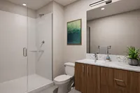 Elegant modern bathroom featuring a spacious glass-enclosed shower, sleek wooden vanity with marble countertop, and stylish wall art, creating a serene oasis.