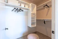 Spacious and organized walk-in closet with modern shelving, elegant hangers, and stylish storage baskets.