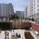 Luxurious apartment courtyard featuring cascading waterfalls, inviting lounge areas, and modern outdoor amenities.