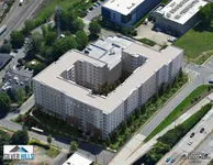 Aerial view of the modern Silver Hills Tryon apartment complex featuring expansive green surroundings and strategically placed near urban amenities.