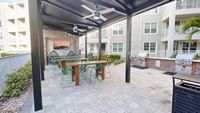 Outdoor entertaining area with grills next to the pool at Triton Cay Fort Myers
