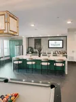 Luxurious community lounge featuring a sleek bar area and modern pool table, enhancing the ultimate social experience at Soltair Cypress Creek.