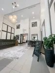 Elegant apartment lobby with high ceilings, modern decor, and welcoming atmosphere at Soltair. Stylish lighting fixtures enhance the sophisticated setting.