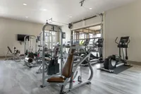 State-of-the-art gym with modern exercise equipment including treadmills and weight machines.