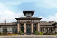 Sophisticated apartment complex with modern architectural design and well-maintained landscaping.