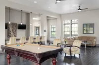 Chic recreation room with billiards table, seating area, and modern decor.