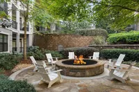 Experience serene relaxation by the fire in this beautifully landscaped outdoor space.
