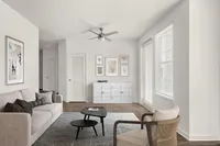 Contemporary living room with modern beige sofa, stylish coffee tables, and chic wall art.