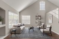 Bright and inviting living room with vaulted ceilings, modern furniture, and elegant decor.