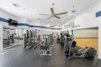 Modern fitness center with state-of-the-art equipment, mirrored walls, and motivational quotes, perfect for an energetic workout.