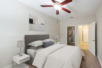 Inviting bedroom featuring a cozy bed, elegant decor, and a well-organized walk-in closet.