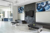 Modern clubhouse with sleek furniture, artistic decor, and striking chandeliers, offering a stylish and inviting ambiance.