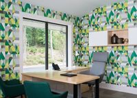 Modern office space with vibrant geometric wall design, large window view, wooden desk, and stylish chairs.