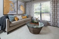 Chic living room with elegant sofa, vibrant cushions, and stylish decor, offering a cozy and inviting atmosphere.