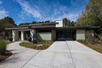 Charming and inviting leasing office with modern design, surrounded by lush greenery and a beautifully paved walkway.