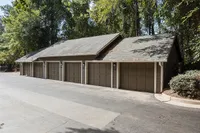 Charming multi-car garage nestled in a serene wooded setting, perfect for secure and convenient parking.