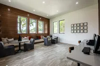 Bright and modern communal space with stylish seating, large windows, and sleek decor, ideal for work or leisure.