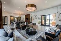 Elegant open living space with modern furnishings, large windows, and a cozy ambiance, perfect for relaxation and entertaining.