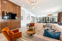 Modern living room with stylish wood accents, plush seating, and elegant lighting, perfect for relaxation and entertainment.