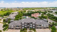 Charming apartment complex with elegant architecture, nestled in lush greenery, offering serene views and modern amenities.