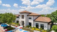 Modern apartment community with Mediterranean-style architecture, lush landscaping, and charming outdoor spaces.