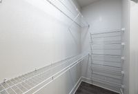 Spacious walk-in closet with organized wire shelving and ample storage space.