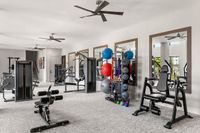 Modern fitness center with state-of-the-art equipment, free weights, and a variety of strength training machines.