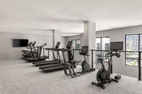 Modern fitness center with state-of-the-art treadmills and exercise bikes, offering a bright and spacious workout environment.