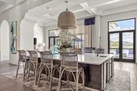 Indoor community area with a large table and chairs with floral decor