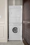 Convenient in-unit stacked washer and dryer in a modern apartment closet, offering efficient use of space.