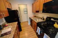 West Chester, PA, Apartments For Rent - Kitchen Has Wood-Inspired Flooring, Wood-Inspired Cabinets, Fridge, Oven, Dishwasher, And A Built-In Microwave.