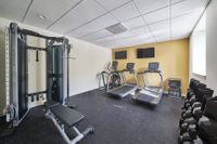 Apartments in Ardmore, PA for Rent - The Athens - Fitness Center with State-Of-The-Art Equipment, Windows, and TVs