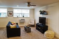 Chic living room with modern furniture, large windows, and stylish decor accents.