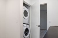 Modern apartment with a sleek, in-unit washer and dryer neatly tucked in a convenient closet space.