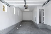 Spacious and pristine garage interior with ample room for parking and storage, featuring bright natural light through sleek windows.