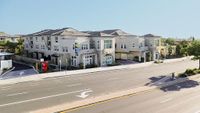 Modern townhome community with stylish architecture, offering spacious living spaces and convenient location on a sunny street.
