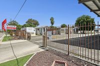 Charming gated mobile home community with palm trees and a serene atmosphere at Desert Sky.