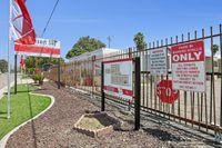 Inviting entrance of Desert Sky Community with vibrant landscaping, welcoming signage, and clear directional markers for new residents.