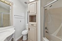Inviting bathroom boasting elegant cabinetry, a sleek sink, and a modern shower enclosure.