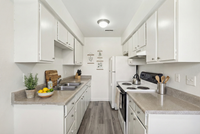 Bright and inviting kitchen with modern white cabinets, sleek countertops, and elegant appliances, perfect for culinary enthusiasts.