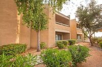 walkway near lush landscaping and 2 story apartment building at Silver Creek Apartments