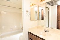 full bath with shower tub combo and beige vanity at silver creek