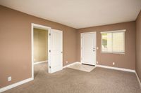 front door and living room with brown carpet at Solaris at The Biltmore