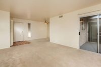 partial view of kitchen and living room with brown carpet at Bridge Lane